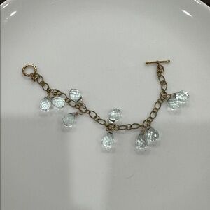 Dangling blue glass and gold chain bracelet